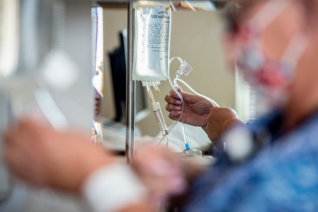 A registered nurse administers intravenous antibiotics to a patient in the medical, surgical and pediatric unit in Asheboro, N.C. on June 7, 2022.