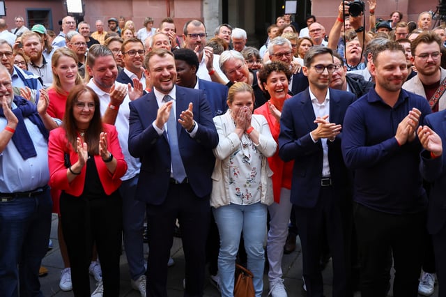 Social Democratic Party (SPD) supporters react after first exit polls of the Brandenburg state election in Potsdam, Germany, September 22, 2024. REUTERS/Fabrizio Bensch