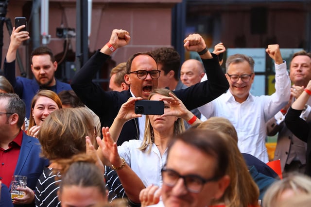 Social Democratic Party (SPD) supporters react after first exit polls of the Brandenburg state election in Potsdam, Germany, September 22, 2024. REUTERS/Fabrizio Bensch
