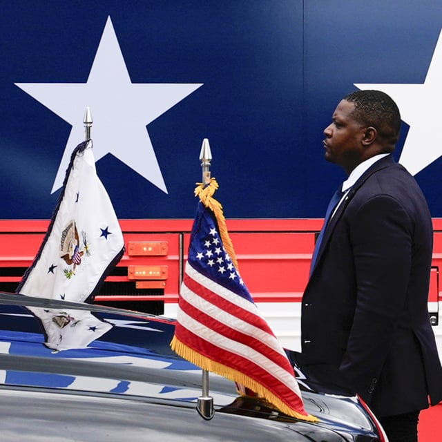 A U.S. Secret Service agent stands watch outside a campaign bus for Democratic presidential nominee Vice President Kamala Harris and her running mate Minnesota Gov. Tim Walz, Aug. 18, 2024, in Rochester, Pa. Lawmakers are trying to ensure that the Secret Service has enough resources to keep the presidential candidates safe.