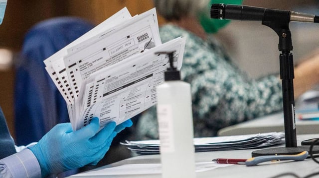 Johnston County Board of Elections members process absentee ballots on Nov. 9, 2020.