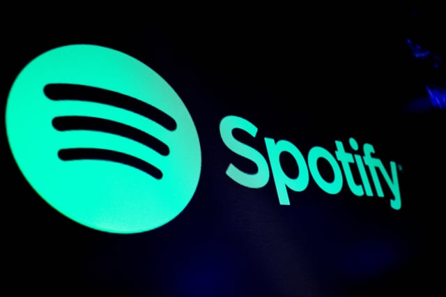 A screen displays the logo of Spotify on the floor at the New York Stock Exchange (NYSE) in New York City, U.S., December 4, 2023.  REUTERS/Brendan McDermid/File Photo